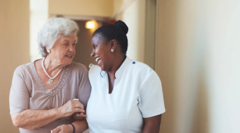 Elderly woman with caregiver